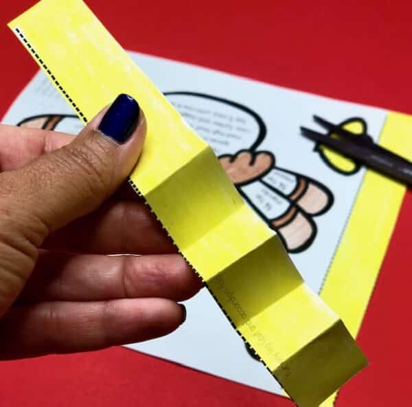 a hand holding a yellow paper